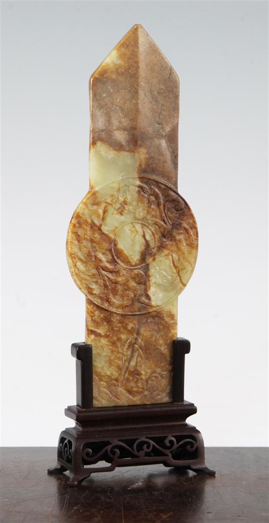 A Chinese yellow and russet jade tablet (gui), Ming dynasty or later, 19.1cm, broken and restored at pointed end, wood stand.